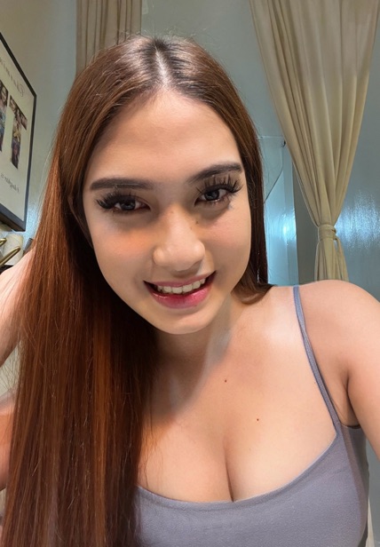 Mara, an adult member from the Philippines, smiling at the camera