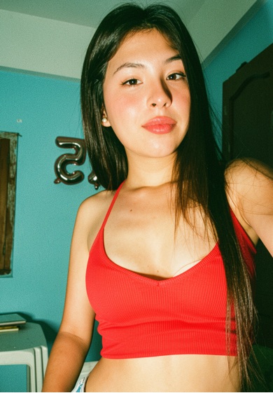 Amara, an adult member from Bolivia, in warm indoor light